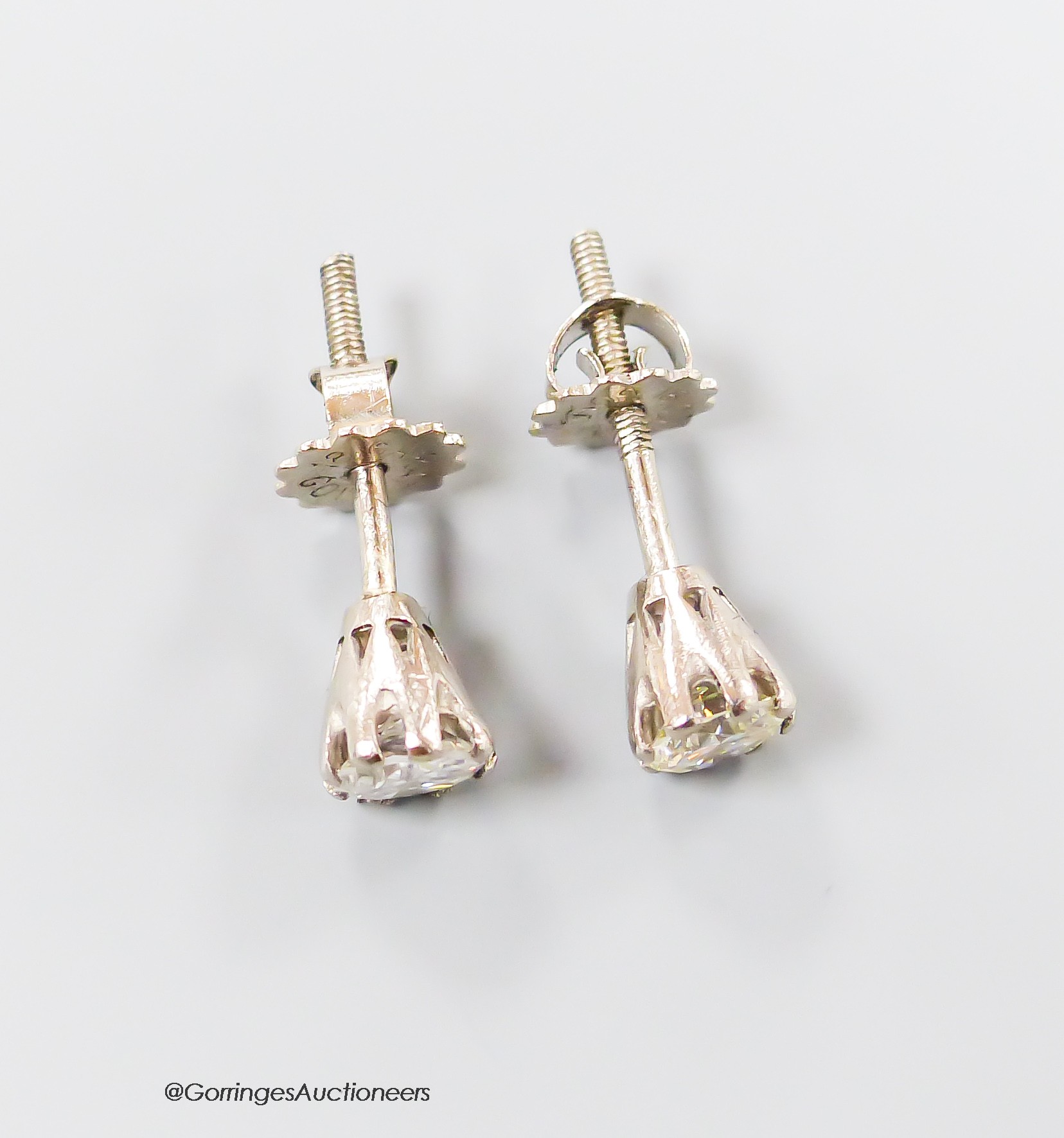 A pair of modern 18ct and solitaire diamond set ear studs, the stones each weighing approximately 0.30ct, gross weight 1.6 grams.